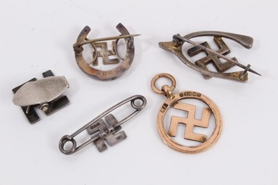 Lot 292 - 9ct gold swastika pendant together with four silver swastika brooches (5)