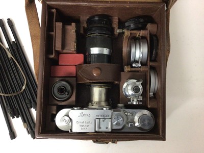 Lot 2355 - Leica III outfit dating from 1935, including body and three lenses (50mm Elmar, 35mm Elmar, 90mm Elmar), close-up lenses, cartridge spool, universal finder, and close up tube set, in original fitte...