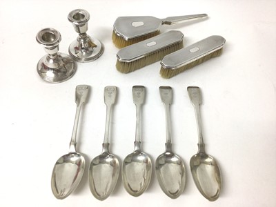 Lot 236 - Five tablespoons all with engraved crest, pair of silver candlesticks and set of three 1930s silver backed dressing table brushes