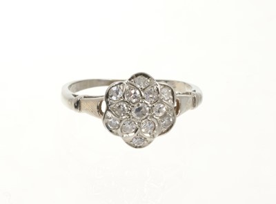 Lot 501 - Diamond cluster ring with a flower head cluster of thirteen single cut diamonds