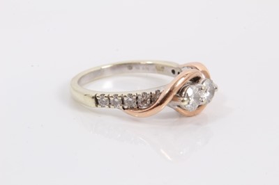 Lot 74 - 14ct white gold diamond two stone ring with rose gold crossover setting and further diamond set shoulders