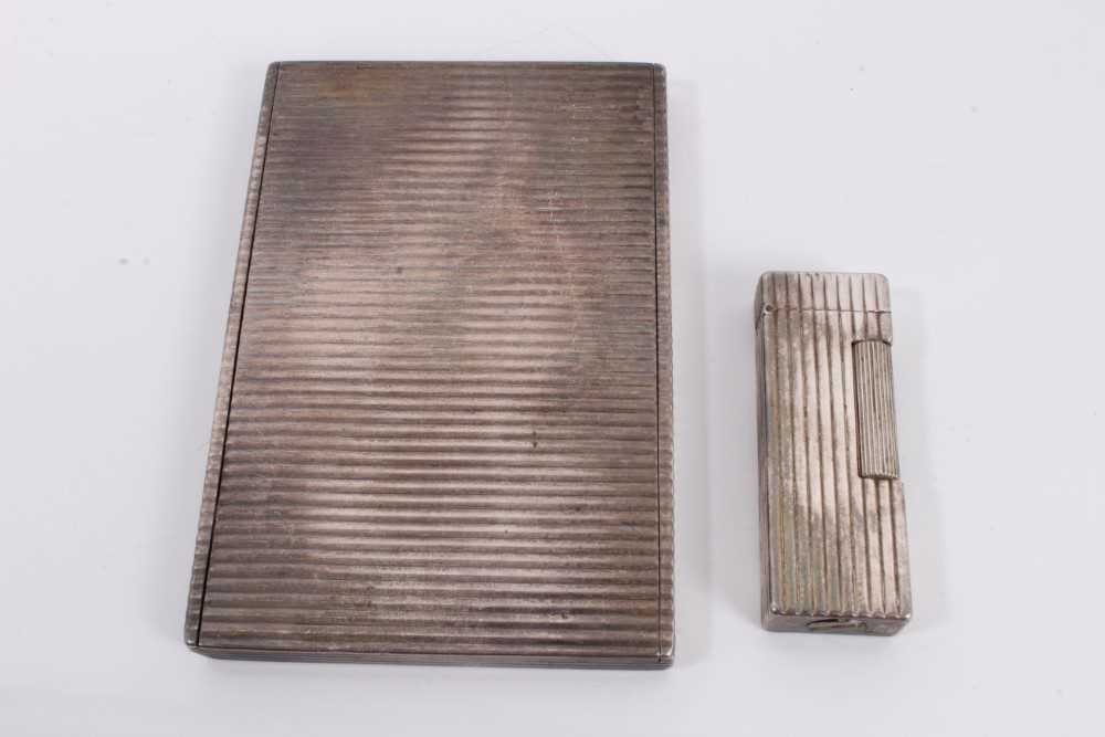Lot 93 - White metal cigarette case with reeded decoration and similar style Dunhill lighter (2)