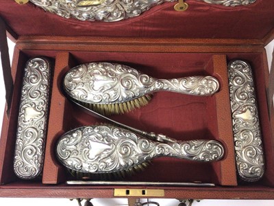 Lot 128 - Late Victorian silver backed dressing table set in fitted brown leather travel case