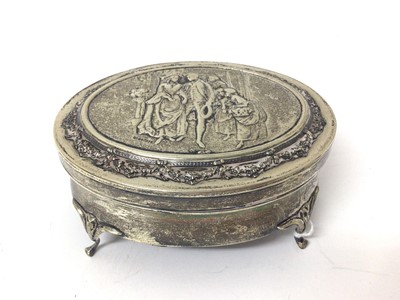 Lot 131 - Edwardian silver oval jewellery box on four legs with relief decoration to lid depicting a couple