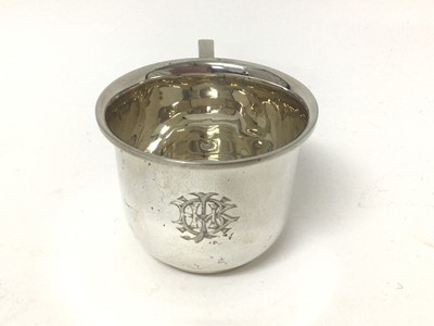 Lot 136 - 1920s silver tea cup with engraved monogram, silver sauce boat, silver vase raised on three legs and silver topped glass jar
