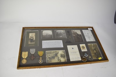 Lot 737 - First World War display mounted in glazed frame, containing piece of Zeppelin L32, shot down near Billericay, Essex, reproduction and period photographs, European medals, cap badges and buttons.