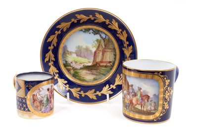 Lot 10 - A Sèvres coffee can and saucer, the can decorated with figures on horseback, the saucer with a military camp, various marks, together with a Vienna can decorated with figures (3)