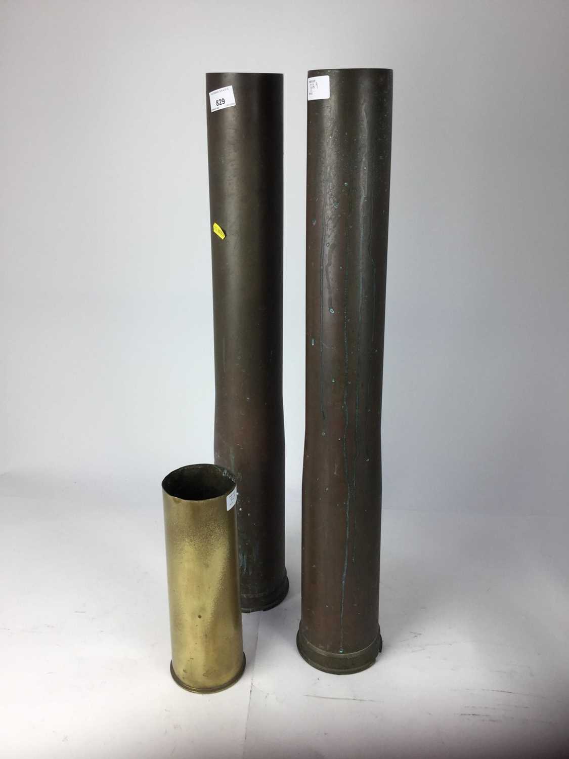 Lot 829 - Three large brass military shell cases