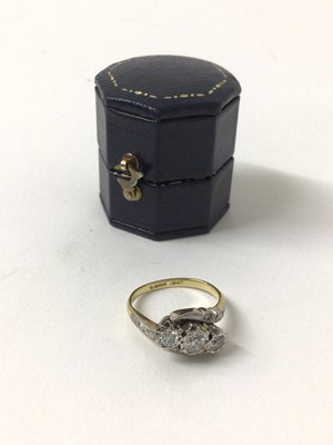Lot 161 - Diamond three stone ring with theee brilliant cut diamonds in platinum cross-over setting on 18ct yellow gold shank