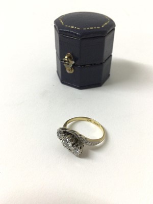 Lot 161 - Diamond three stone ring with theee brilliant cut diamonds in platinum cross-over setting on 18ct yellow gold shank