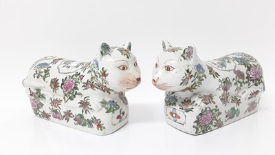 Lot 58 - Large pair of Chinese famille rose porcelain models of cats, 20th century, painted with flowers, seal marks to bases, 31cm long