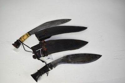 Lot 917 - Two late 19th/ early 20th century Kukris , one with horn hilt, both with leather covered sheaths (2)