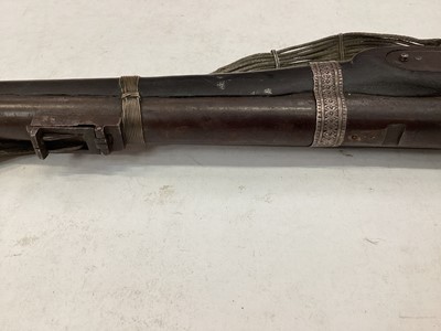 Lot 997 - 19th century Indian musket with Enfield lock dated 1878, V.R.I stamped stock with native decoration and alterations with decorative silver wire shoulder strap 142 cm