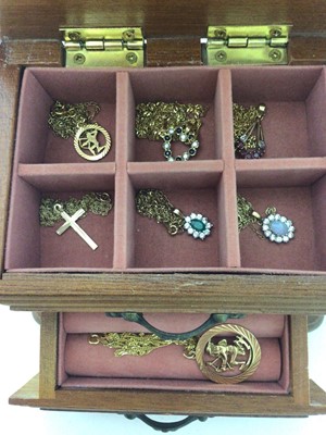 Lot 253 - Seven 9ct gold pendants all on 9ct gold chains in a small wooden jewellery box