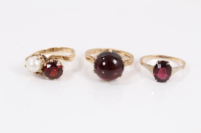 Lot 277 - 9ct gold cultured pearl and garnet two stone cross over ring, 9ct gold red cabochon ring and one other 9ct gold gem set ring (3)