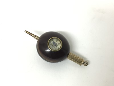 Lot 174 - An unusual combination propelling pencil and compass mounted in a nut or seed, 2.5cm across