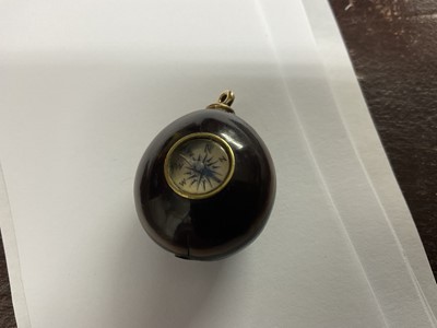 Lot 174 - An unusual combination propelling pencil and compass mounted in a nut or seed, 2.5cm across