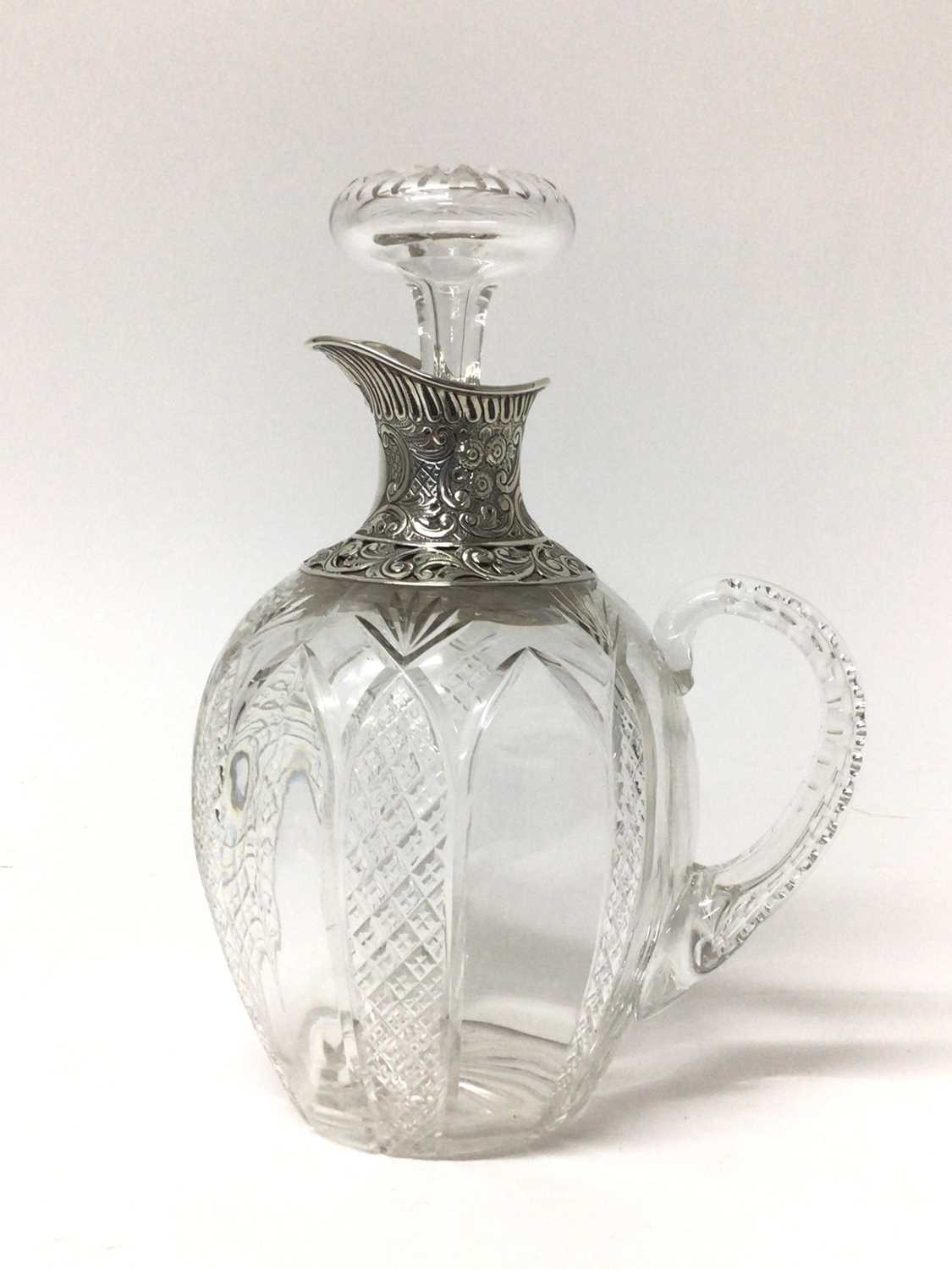 Lot 194 - Edwardian silver mounted cut glass claret jug with embossed and pierced silver spout and collar, the ovoid body with diamond cut decoration. Birmingham 1905. Height 22cm.
