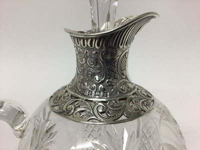 Lot 194 - Edwardian silver mounted cut glass claret jug with embossed and pierced silver spout and collar, the ovoid body with diamond cut decoration. Birmingham 1905. Height 22cm.