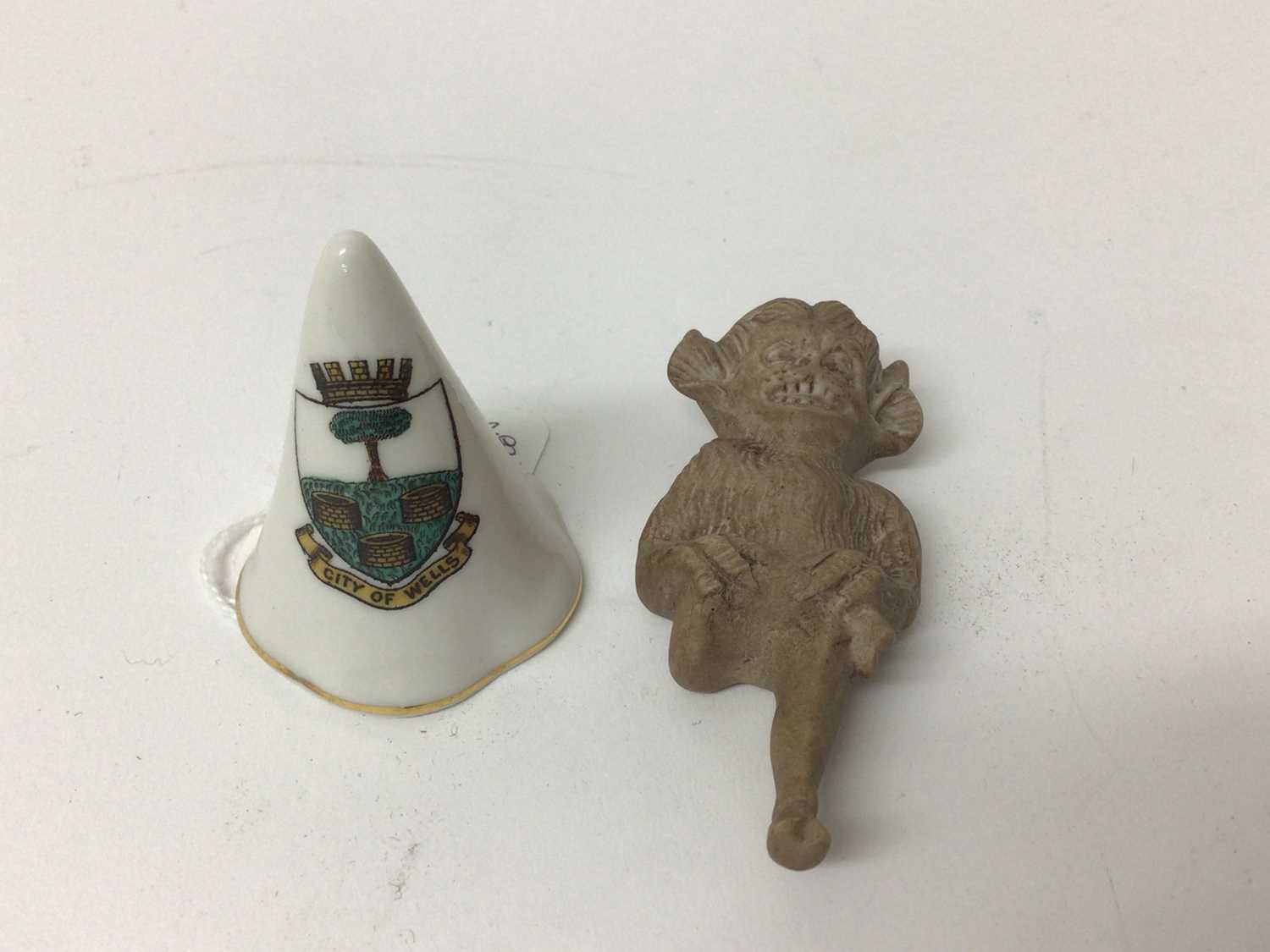 Lot 209 - Rare Goss porcelain figure of 'The Lincoln Imp' 7.5 cm and Goss City of Wells crested candle snuffer (2)