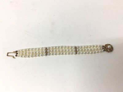 Lot 215 - Cultured pearl bracelet with a triple strand of 6mm cultured pearls on a 9ct gold clasp, 18cm.