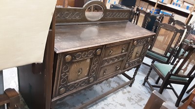 Lot 1037 - 1930s Jacobean Revival carved oak sideboard, together with a set of six 1930s oak dining chairs and draw leaf table