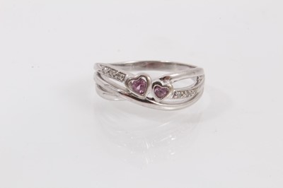 Lot 497 - Diamond and pink sapphire ring with two heart shaped pink sapphires and diamond set shoulders in triple band cross over setting on 9ct white gold shank