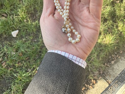 Lot 407 - Natural pearl necklace with diamond clasp