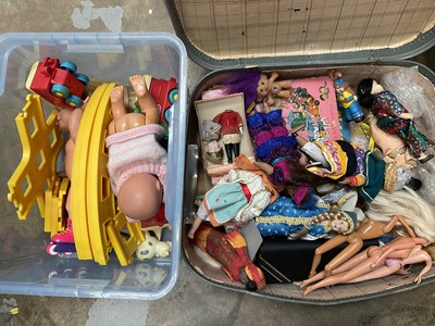 Lot 172 - Suitcase, dolls and a train set, including two barbie dolls