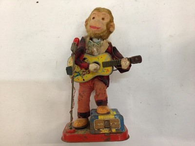 Lot 1973 - Japanese tinplate automaton toy battery operated Monkey with guitar.