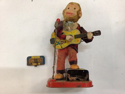 Lot 1973 - Japanese tinplate automaton toy battery operated Monkey with guitar.