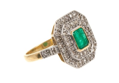Lot 476 - Art Deco emerald and diamond cluster ring with a central rectangular step cut emerald surrounded by an octagonal double border of brilliant cut diamonds, on 18ct gold shank.