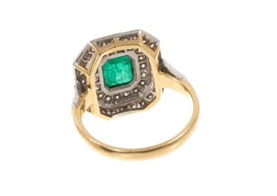 Lot 476 - Art Deco emerald and diamond cluster ring with a central rectangular step cut emerald surrounded by an octagonal double border of brilliant cut diamonds, on 18ct gold shank.