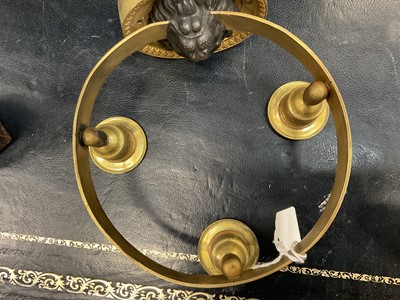 Lot 742 - Pair of Empire bronze and ormolu three light wall appliqués, with lion mask boss wall mount supporting tooled projecting ring with three sconces, 19cm wide