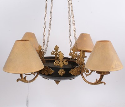 Lot 763 - Empire style four branch gilt metal ceiling light, compressed form, applied with floral bosses and anthemion ornament, with scrolling arms, suspended from chains to conforming ceiling mount, 36cm d...