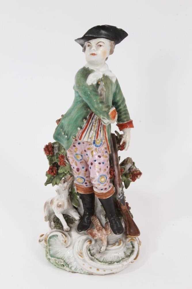Lot 14 - A Derby figure of a sportsman with a dog - unusual red anchor mark