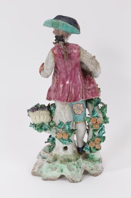 Lot 15 - A Bow figure of a young man with flowers and fruits, circa 1765