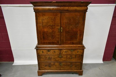 Lot 1404 - Early 18th century walnut veneered secretaire chest on chest, the top with frieze drawer, fitted interior with pigeon holes and drawers enclosed by two doors, the base with two short and two long d...