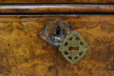 Lot 1404 - Early 18th century walnut veneered secretaire chest on chest, the top with frieze drawer, fitted interior with pigeon holes and drawers enclosed by two doors, the base with two short and two long d...