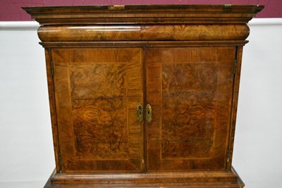 Lot 1404 - Early 18th century walnut veneered secretaire chest on chest, the top with frieze drawer, fitted interior with pigeon holes and drawers enclosed by two doors, the base with two short and two long d...