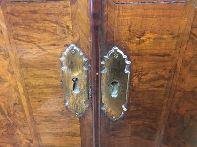 Lot 1404 - Early 18th century walnut veneered secretaire chest on chest, the top with frieze drawer, fitted interior with pigeon holes and drawers enclosed by two doors, the base with two short and two long d...