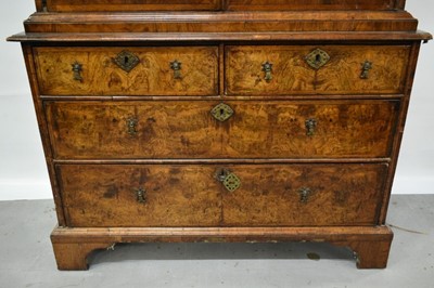 Lot 1404 - Early 18th century walnut veneered secretaire chest on chest, the top with frieze drawer, fitted interior with pigeon holes and drawers enclosed by two doors, the base with two short and two long d...