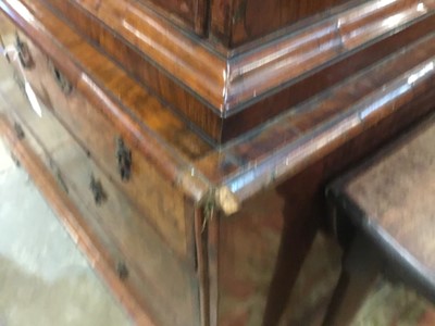 Lot 1404 - Early 18th century walnut veneered secretaire chest on chest, the top with frieze drawer, fitted interior with pigeon holes and drawers enclosed by two doors, the base with two short and two long d...