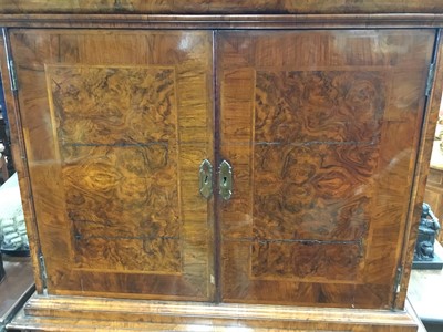 Lot 1404 - Early 18th century walnut veneered secretaire chest on chest, the top with frieze drawer, fitted interior with pigeon holes and drawers enclosed by two doors, the base with two short and two long d...