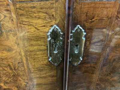 Lot 1404 - Early 18th century walnut veneered secretaire chest on chest, the top with frieze drawer, fitted interior with pigeon holes and drawers enclosed by two doors, the base with two short and two long d...