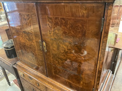 Lot 1404 - Early 18th century walnut veneered secretaire chest on chest, the top with frieze drawer, fitted interior with pigeon holes and drawers enclosed by two doors, the base with two short and two long d...