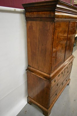 Lot 1404 - Early 18th century walnut veneered secretaire chest on chest, the top with frieze drawer, fitted interior with pigeon holes and drawers enclosed by two doors, the base with two short and two long d...