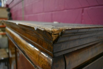 Lot 1404 - Early 18th century walnut veneered secretaire chest on chest, the top with frieze drawer, fitted interior with pigeon holes and drawers enclosed by two doors, the base with two short and two long d...