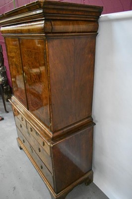 Lot 1404 - Early 18th century walnut veneered secretaire chest on chest, the top with frieze drawer, fitted interior with pigeon holes and drawers enclosed by two doors, the base with two short and two long d...