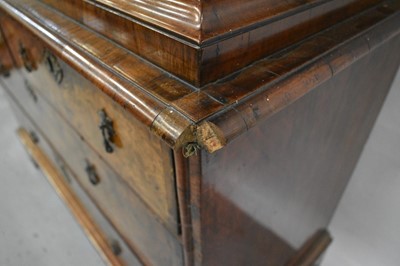 Lot 1404 - Early 18th century walnut veneered secretaire chest on chest, the top with frieze drawer, fitted interior with pigeon holes and drawers enclosed by two doors, the base with two short and two long d...